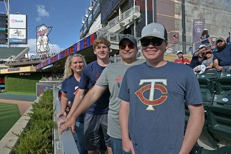A group of people standing in front of a stadium.