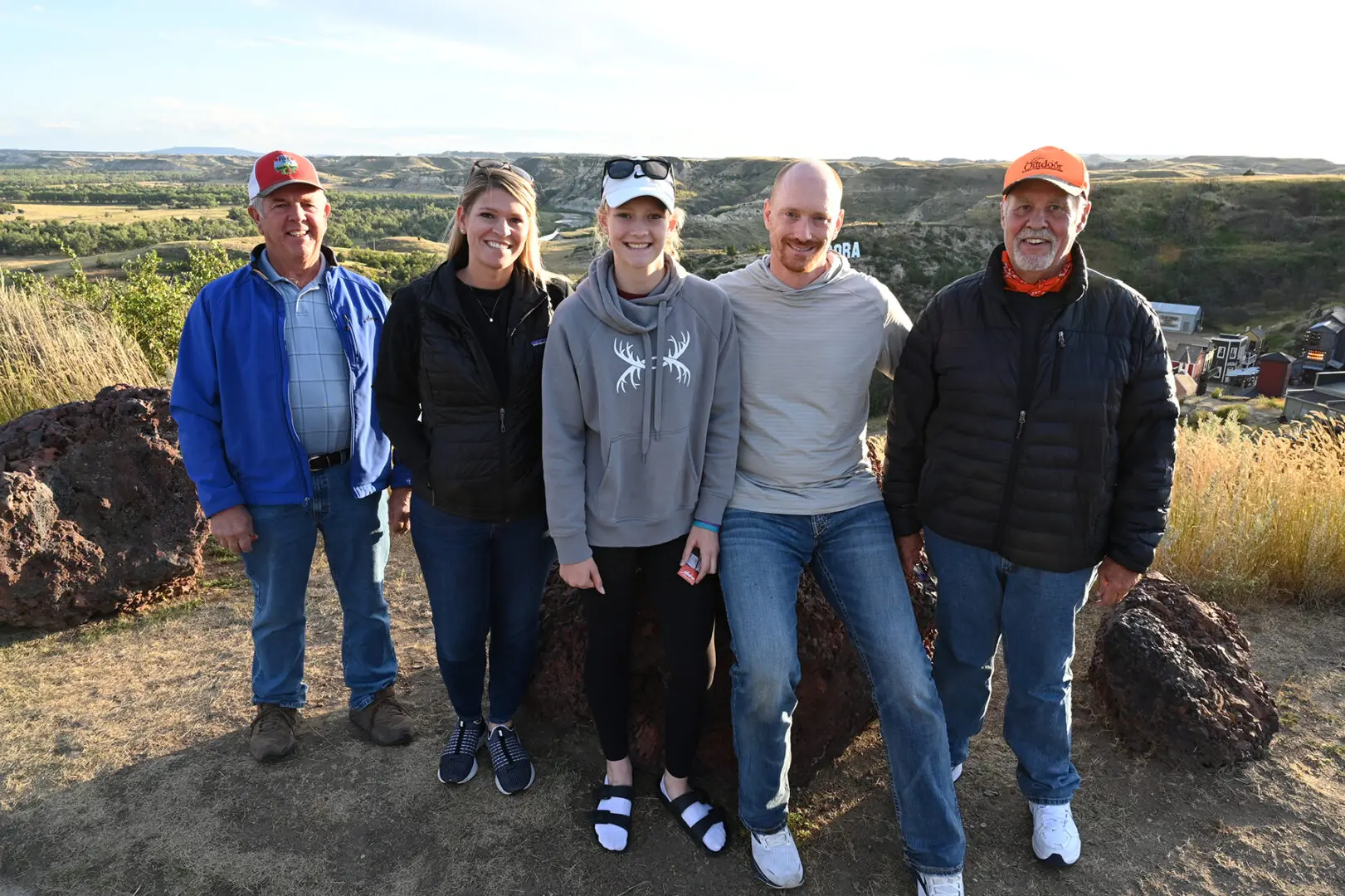 A group of people standing on top of a hill.