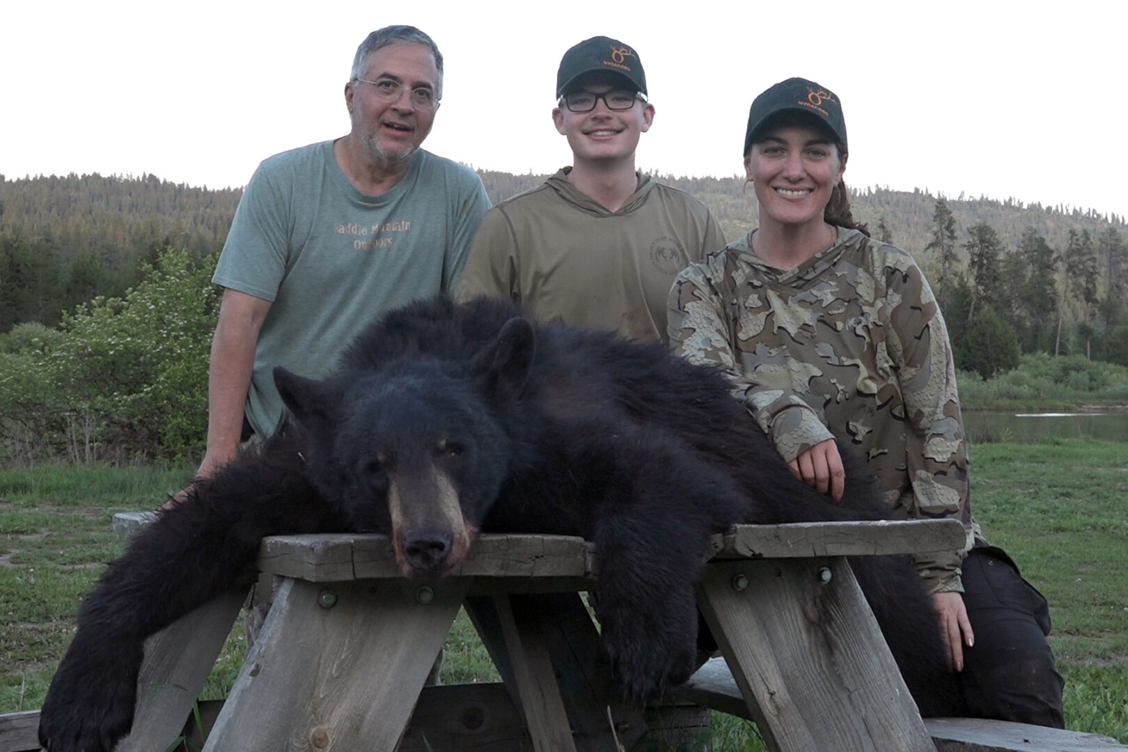 A group of people standing next to a bear.