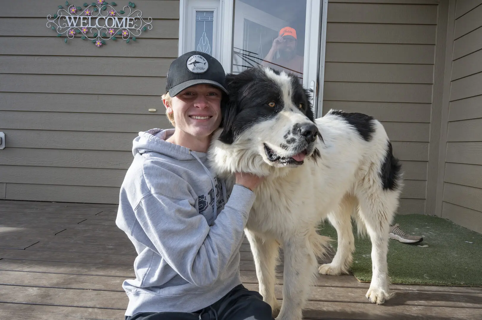 Dash Olsen plays with the Brusseau New Foundland dog, Bo.