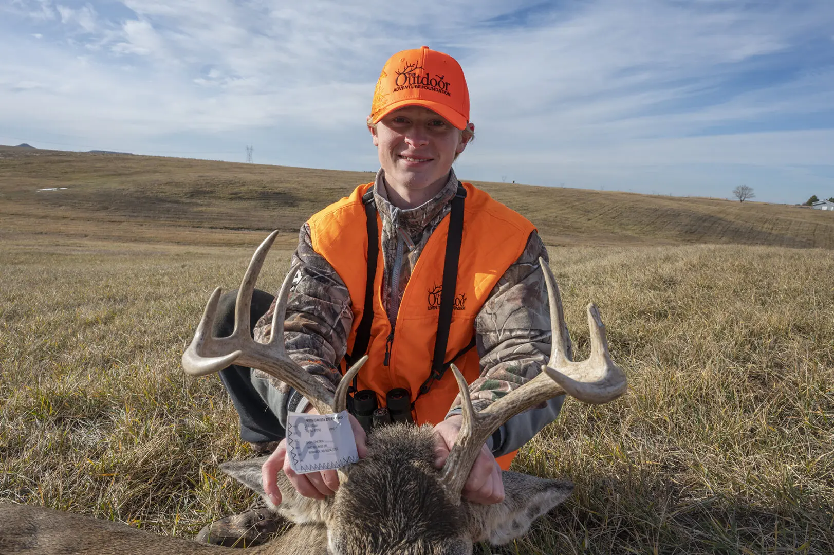 Dash Olsen holding his white-tailed buck