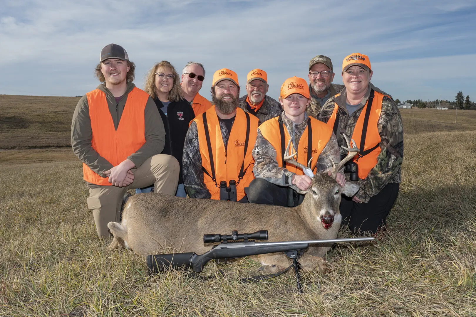 From left to right Tyler Brusseau, Carol Brusseau, Chad Brusseau, Taner Ohlsen, Brian Solum, Dash Ohlsen, Dave Lipp and Kara Ohlsen pose for a photo with Dash's white-tailed buck